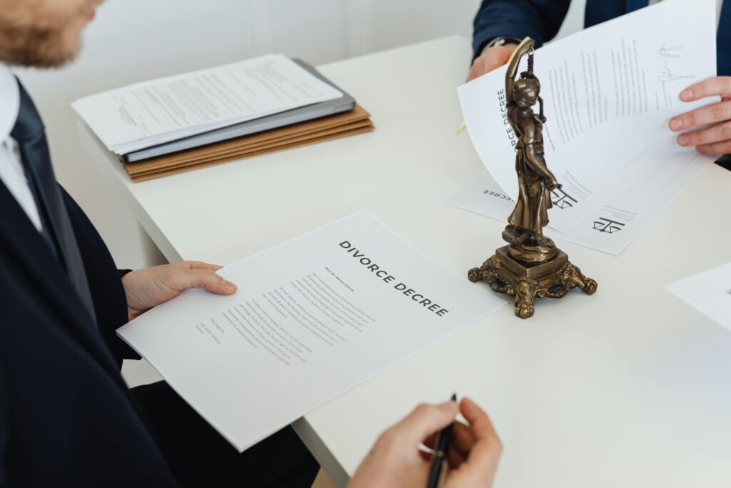 Two professionals discuss divorce decree documents, focusing on legal negotiations.